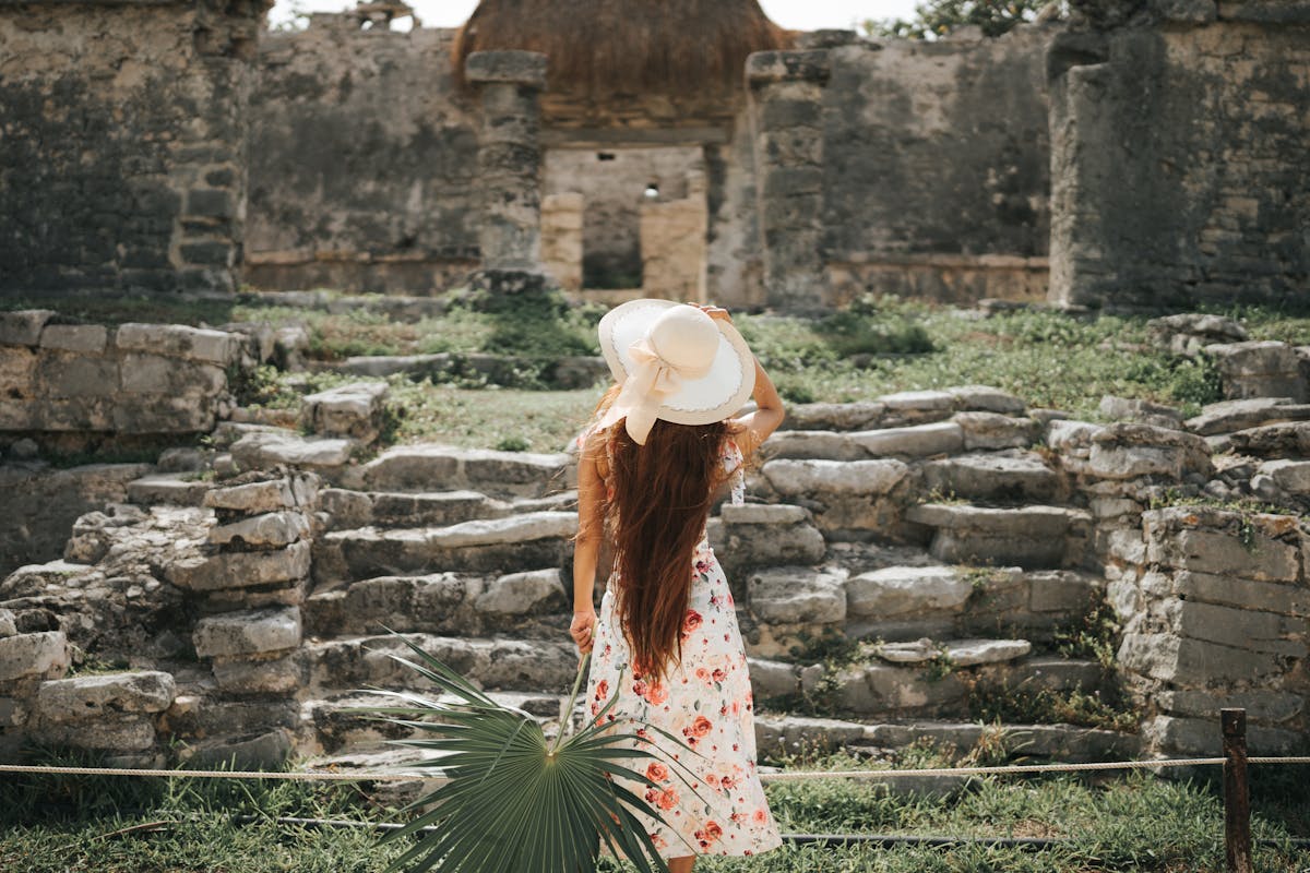 Tourist exploring Tulum Mayan ruins - day trip from Playa del Carmen